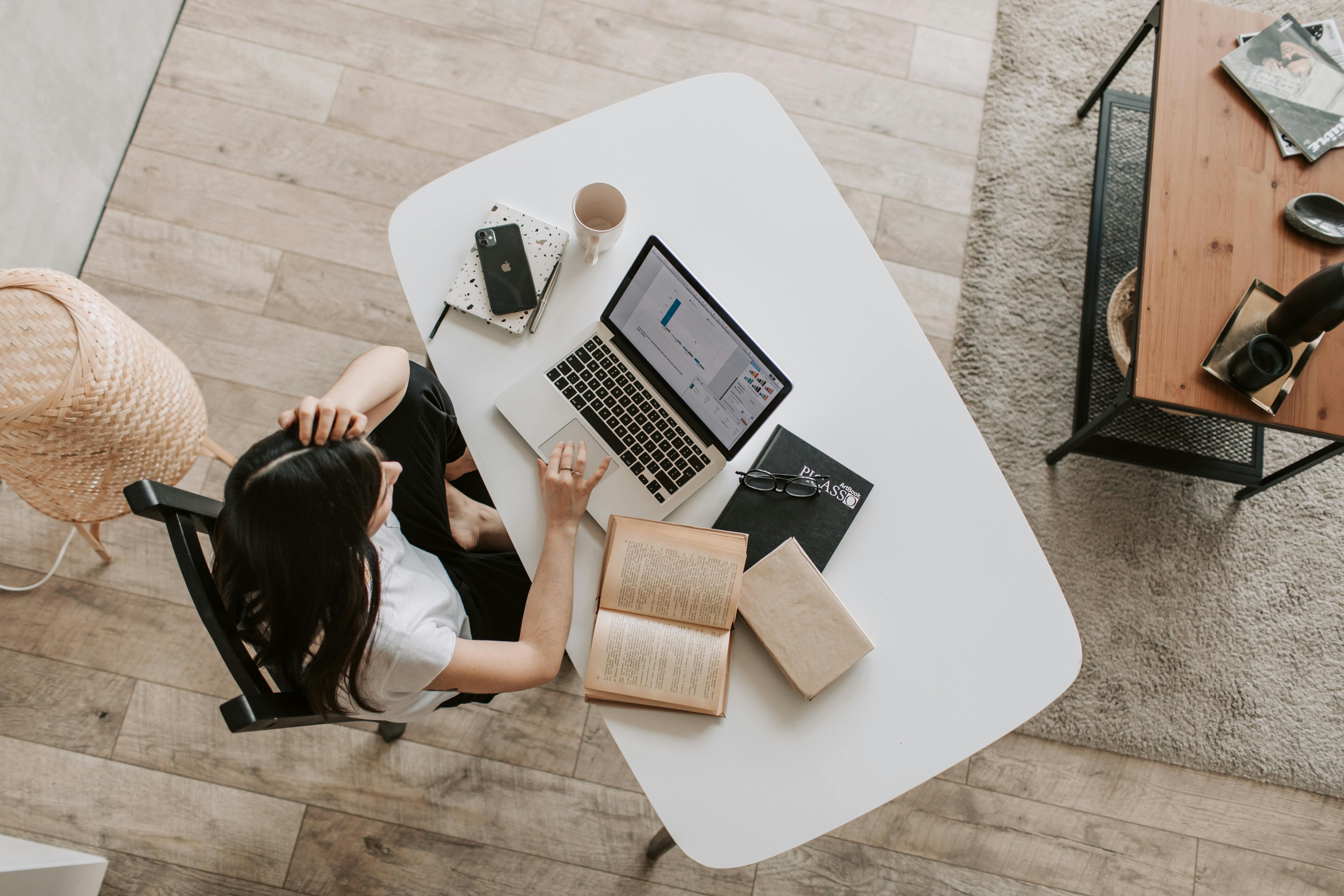 Professional accountant optimizing website for SEO on a laptop surrounded by financial documents