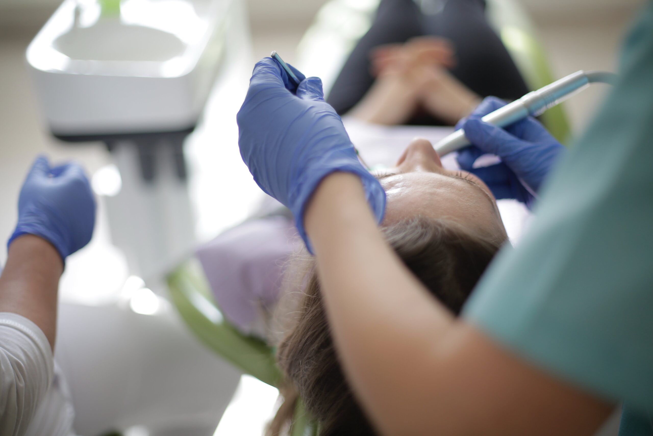 Dental Practice Marketing is Smiling dentist holding a tooth model.