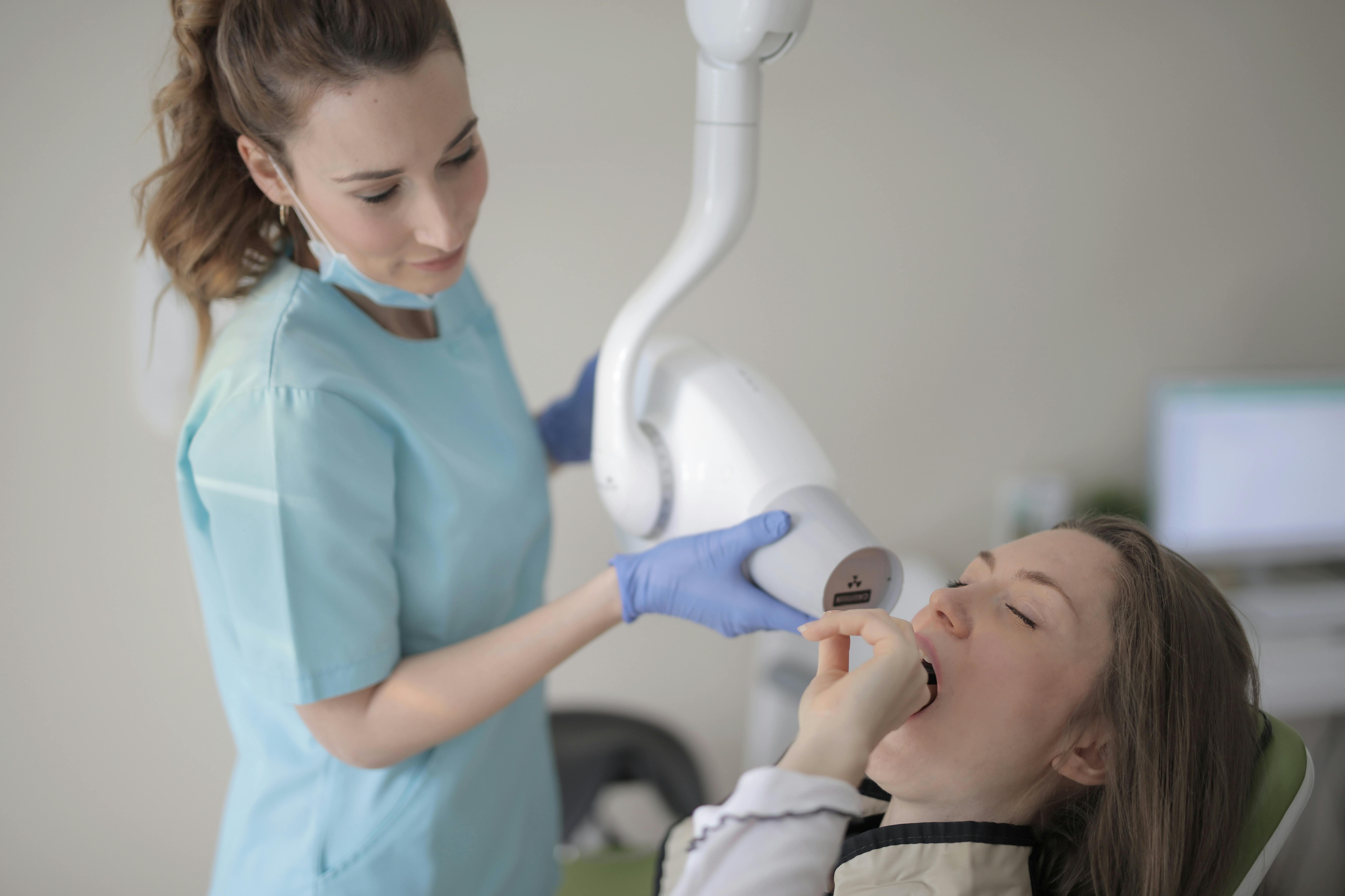 Dental Practice Marketing is Smiling dentist holding a tooth model.